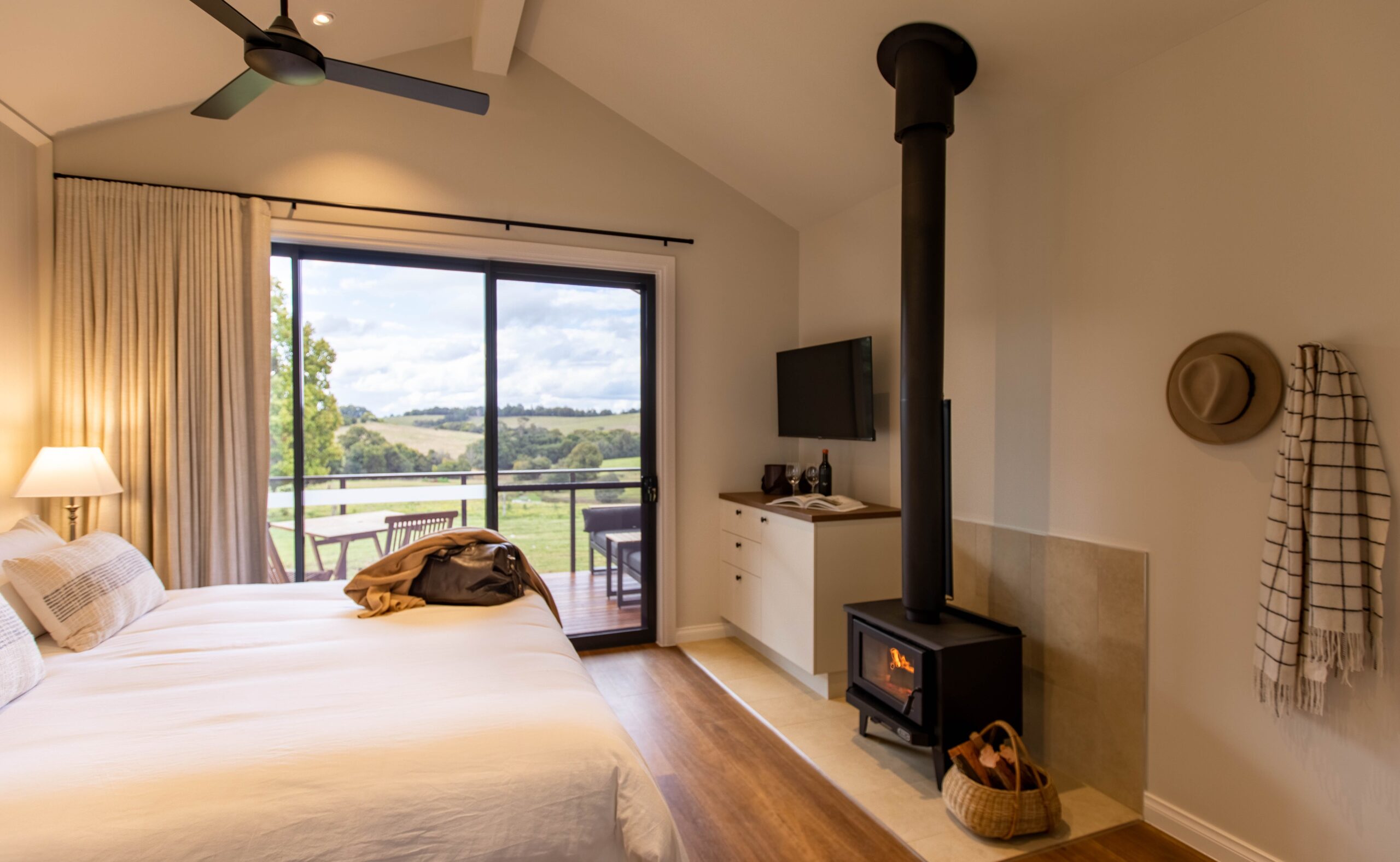 Interior of King Farm cabin at Hazelwood with fireplace and views of rolling hills