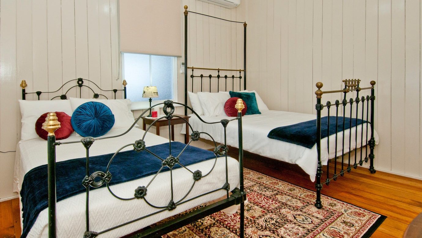 Original bedroom featuring vintage iron beds. Choose from a three-quarter (king single)or double bed