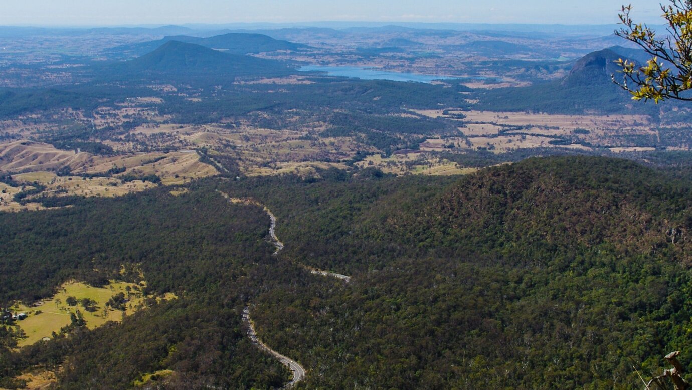 View of mountains, road, lake, farmland and forest.