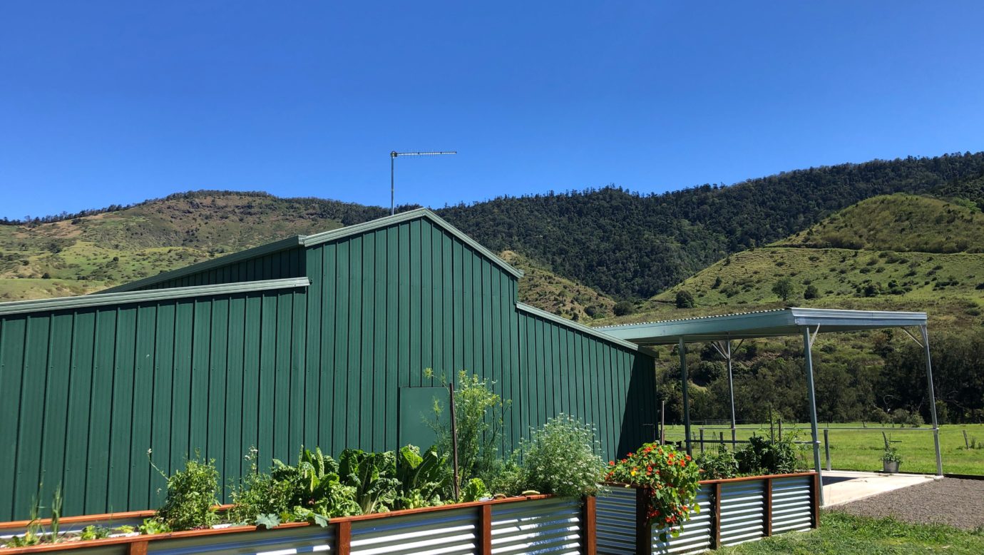 The Tractor Shed and Porch features beautiful mountainous views and market garden beds to walk .