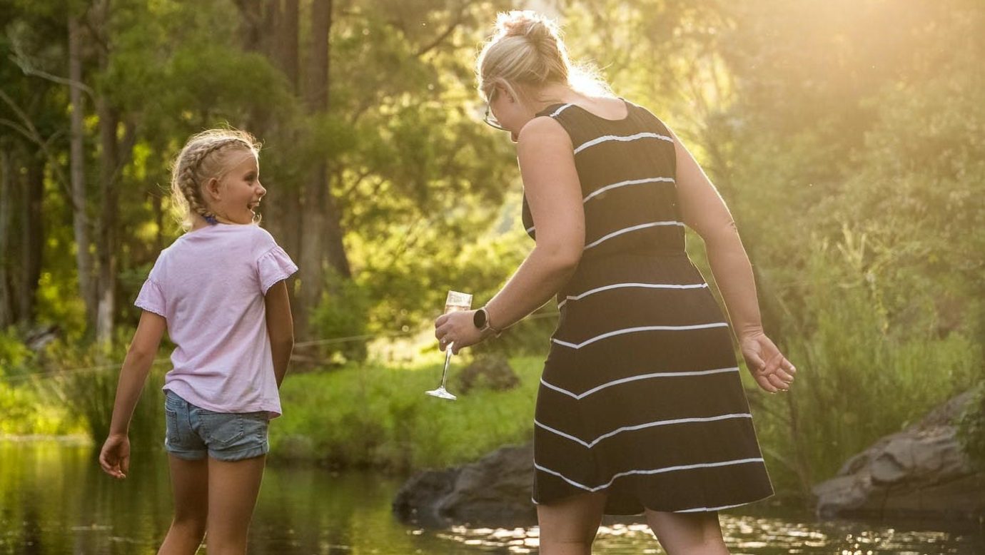 Afternoon light with a woman and young girl paddling down Stockyard Creek.