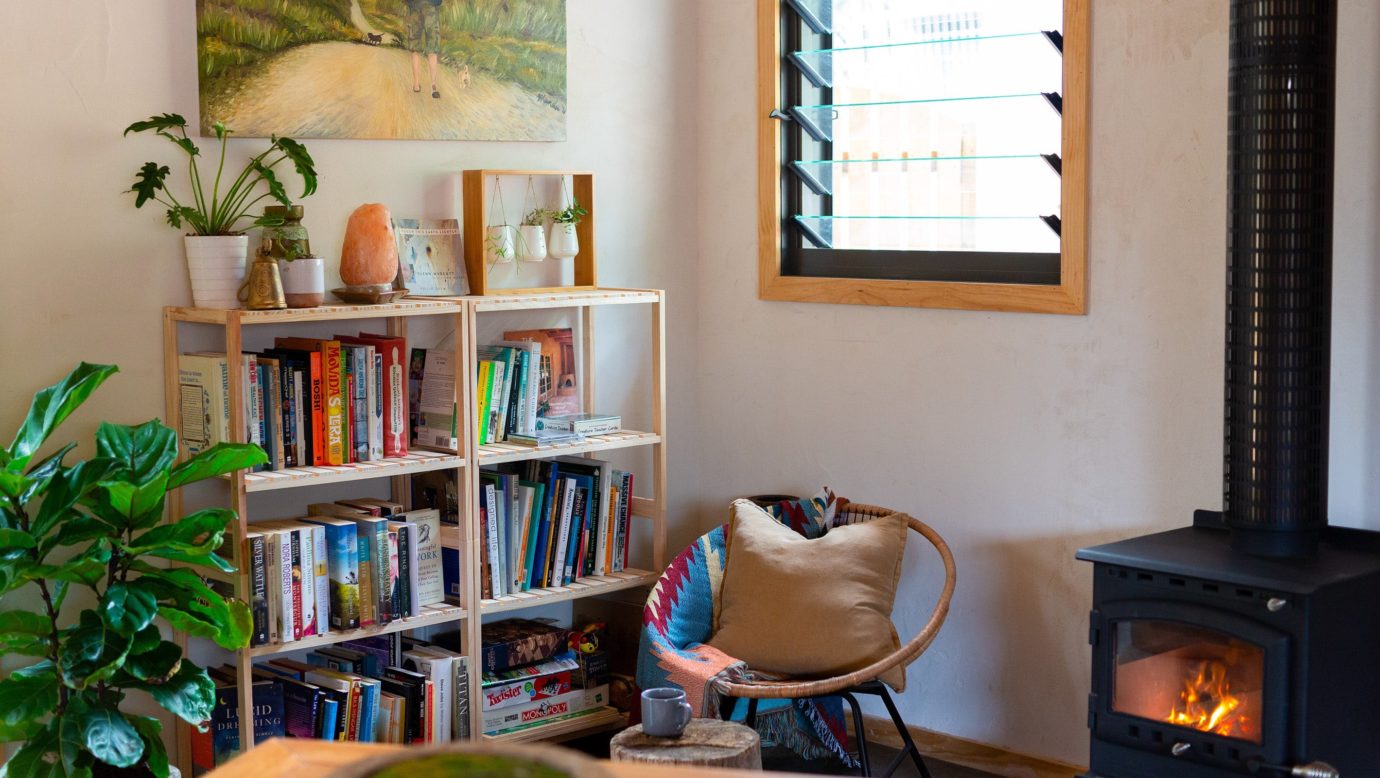 living room with fireplace and library