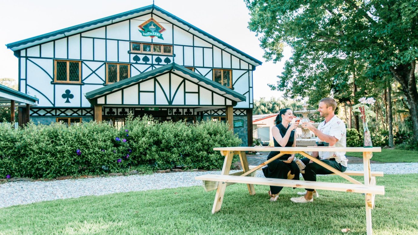 Coupple drinking in front Distillery