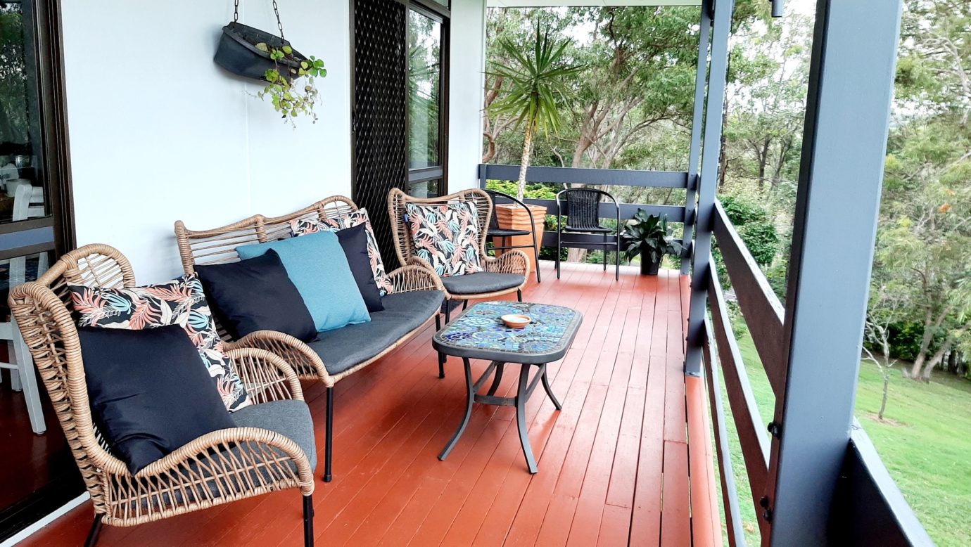 Lounge setting on the front balcony with lake and mountain views.