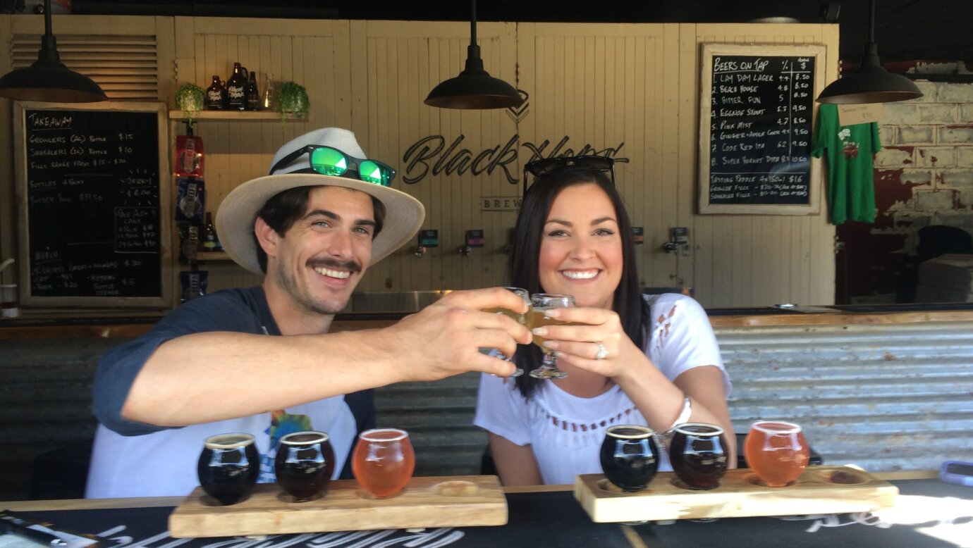 A couple enjoying beers at Black Hops