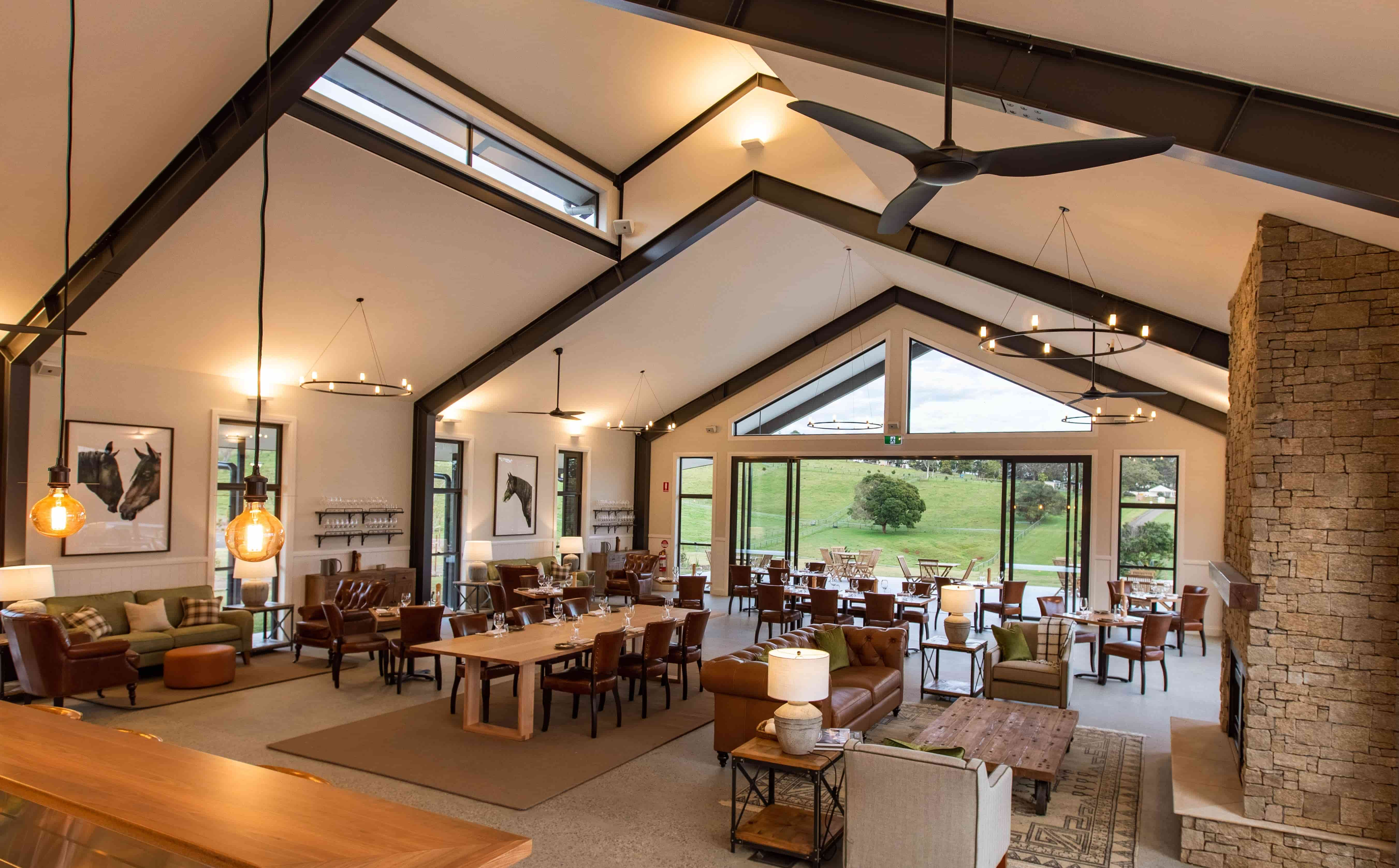 The Paddock restaurant interior featuring floor-to-ceiling windows that maximise hinterland views