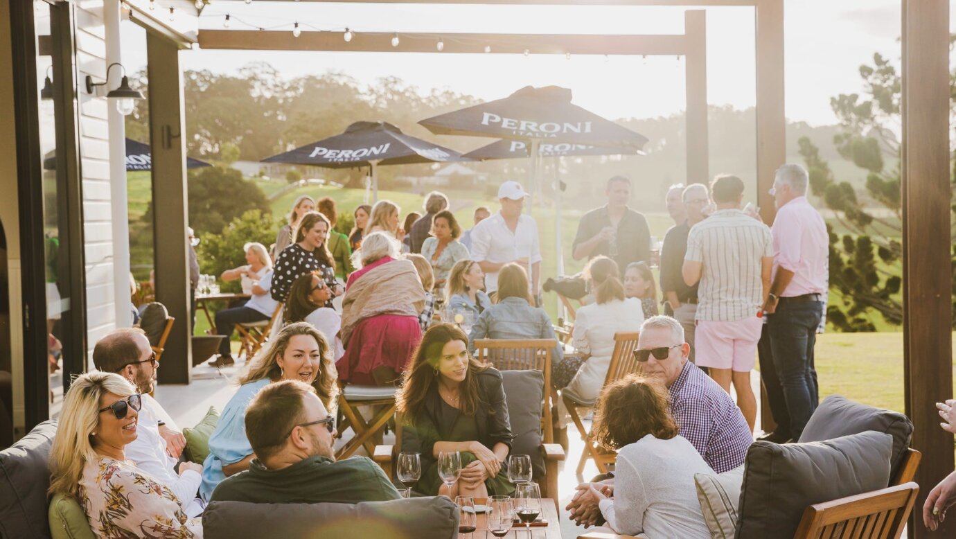 Guests enjoying a drink on The Paddock restaurant's Sunset Terrace