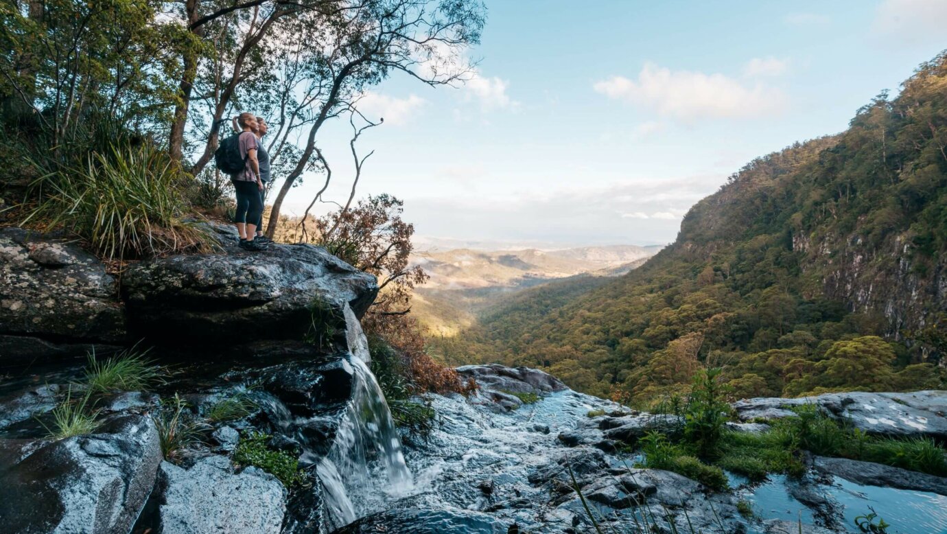 Walkers at the top of Morans Falls in Lamington National Park, Scenic Rim