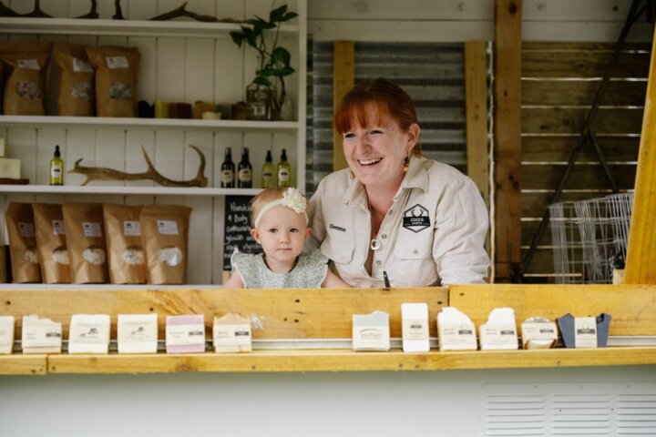 Business owner Gemma and her daughter standing in the farm gate shop surrounded by products