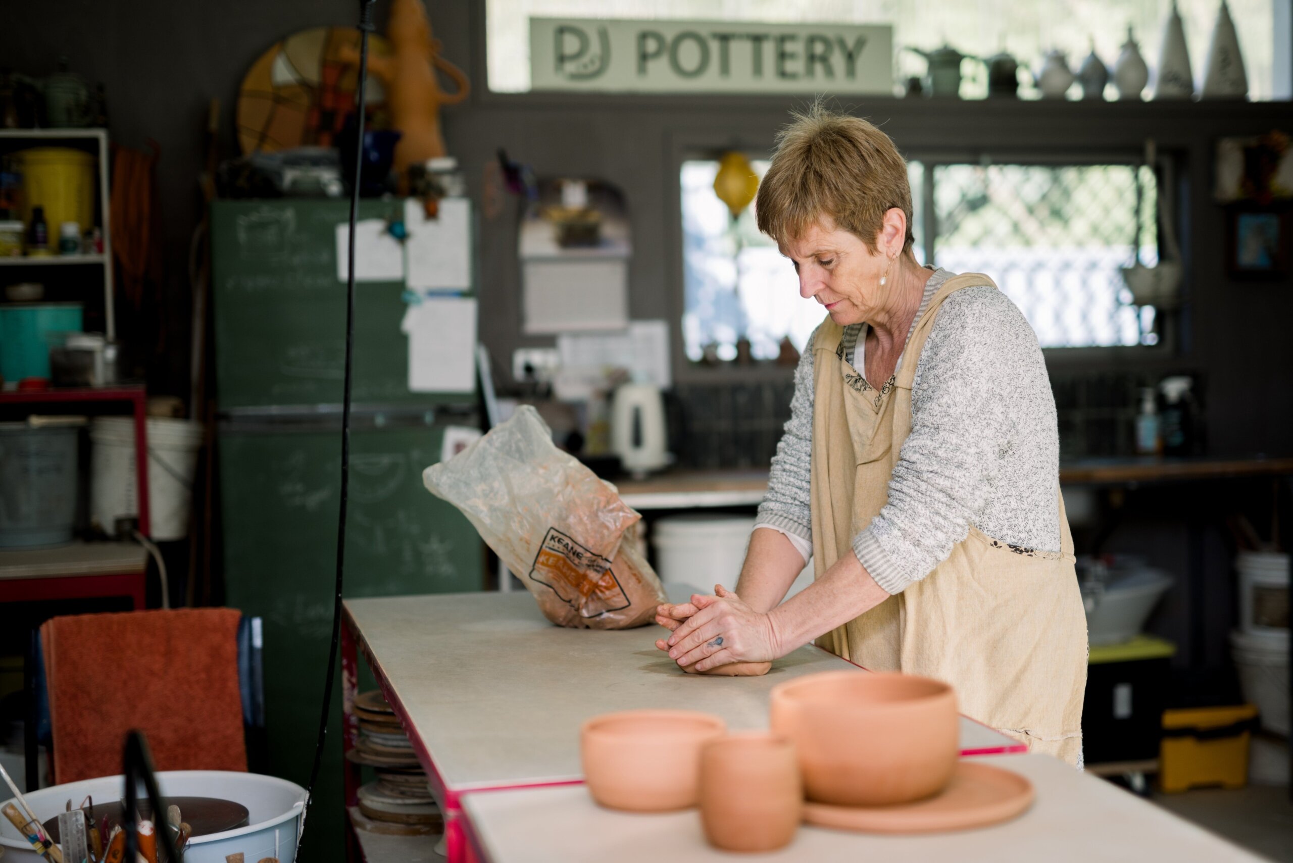 potter in studio making pots