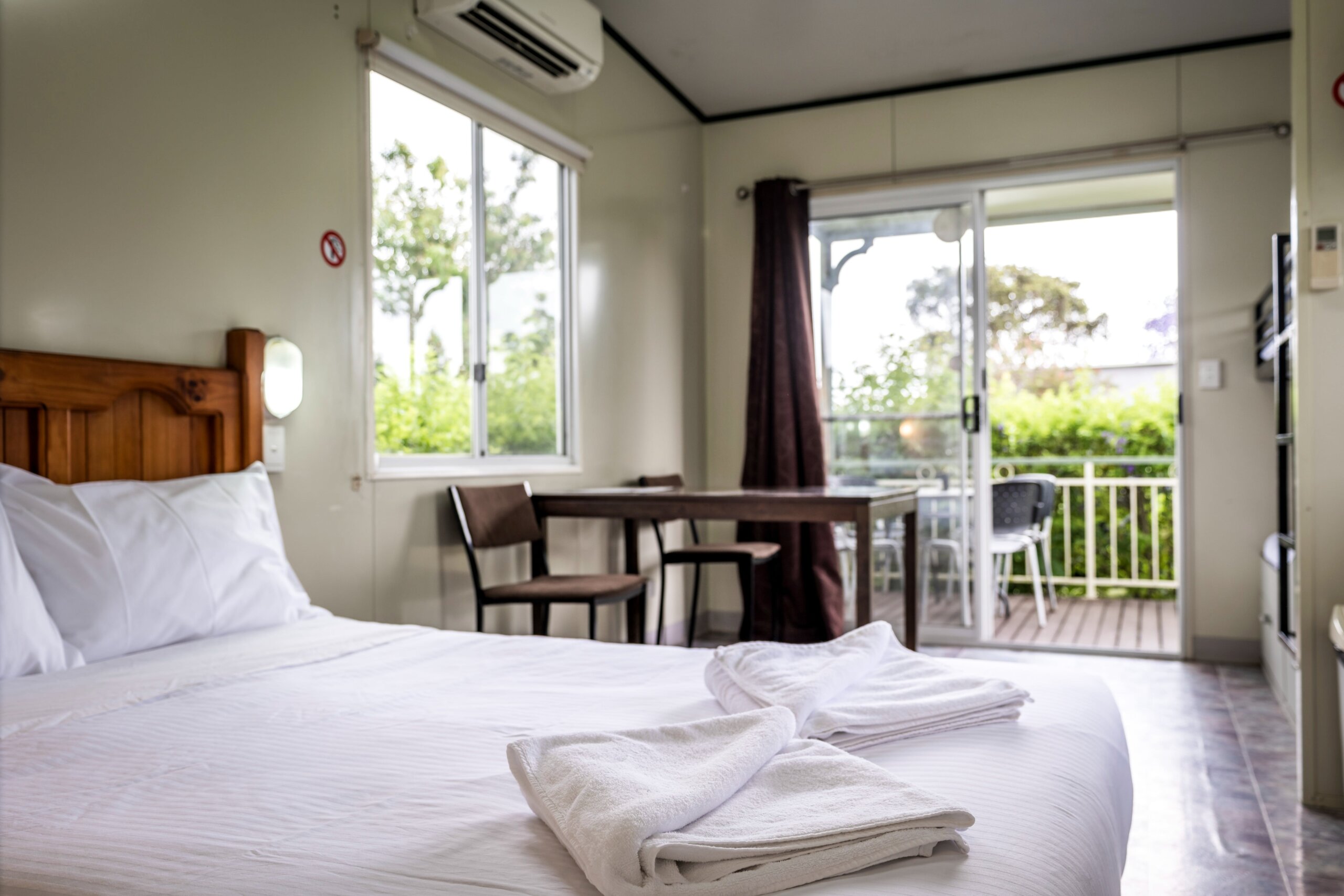 Our four berth cabin's double bed, with a view of the outdoor balcony area.