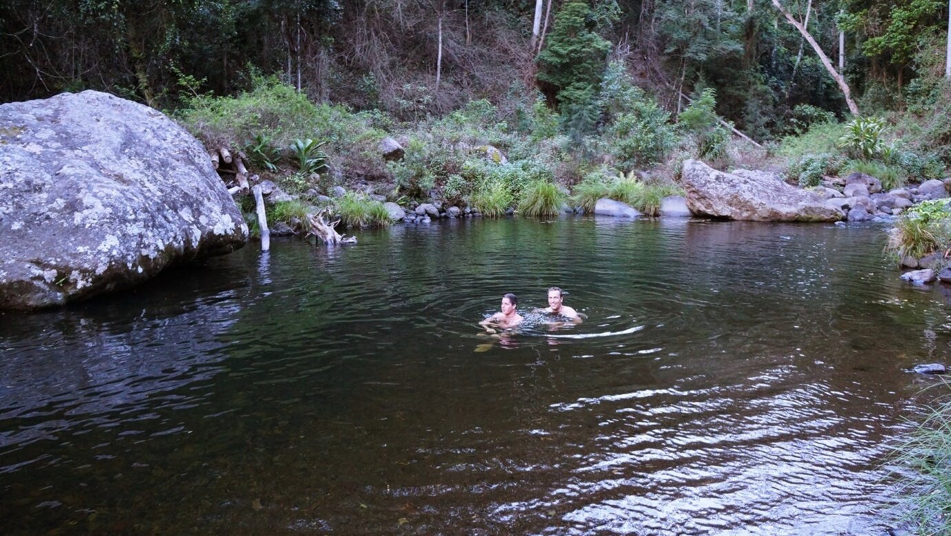Two Visiting Swimmers in a Natural Olympic Size Swimming Pool