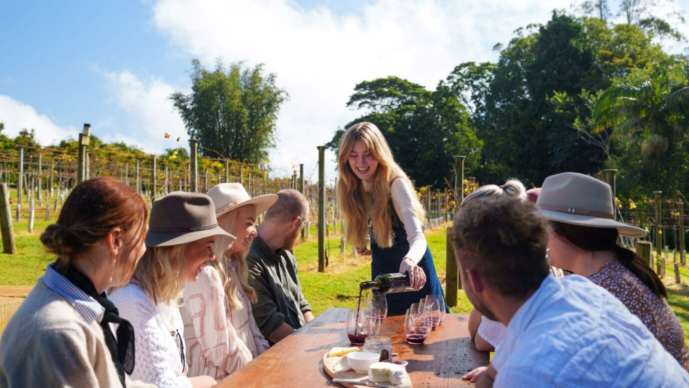 guests outside at table being poured wine