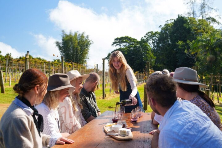 guests outside at table being poured wine