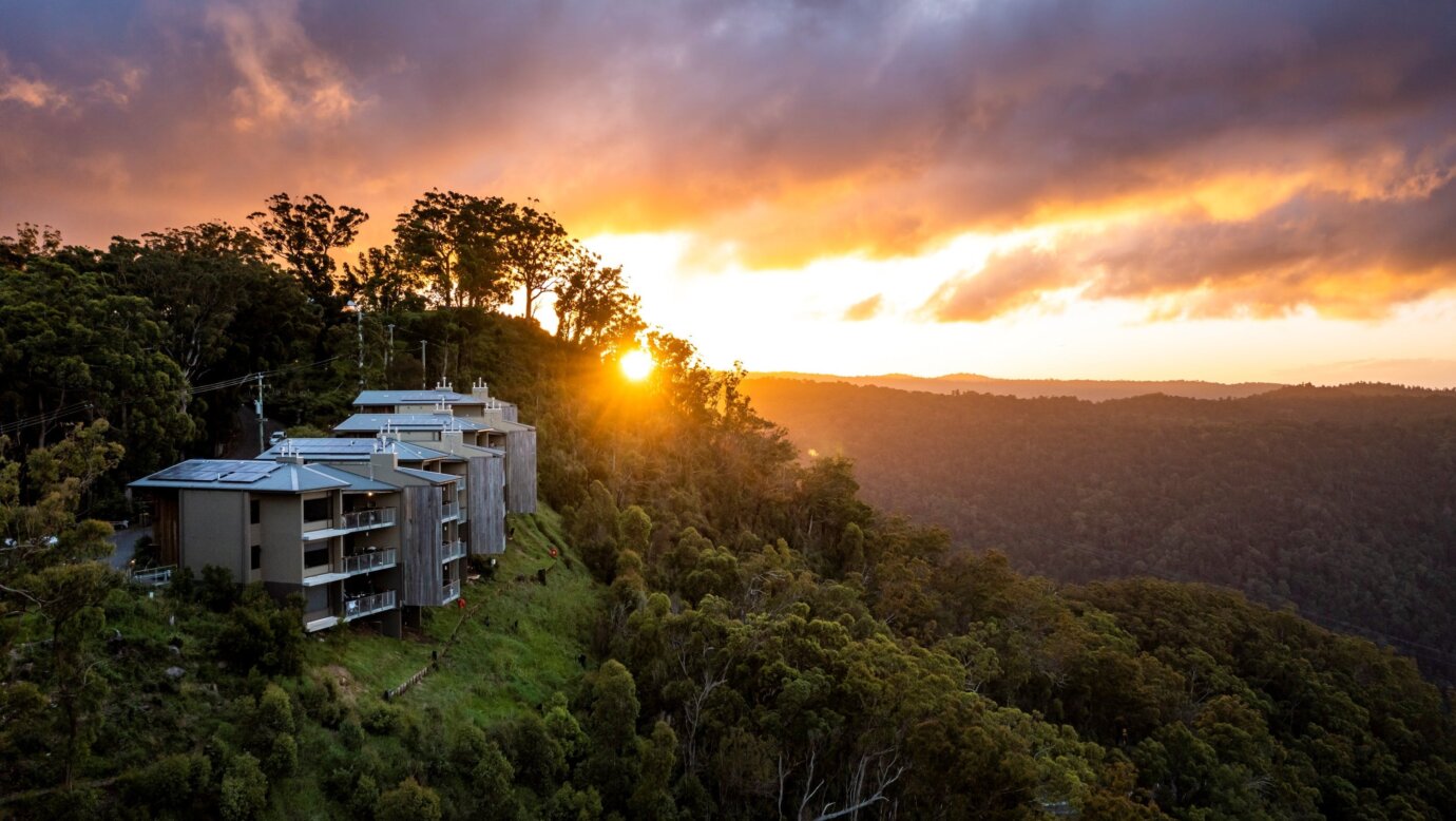 Accommodation on a hillside at sunset