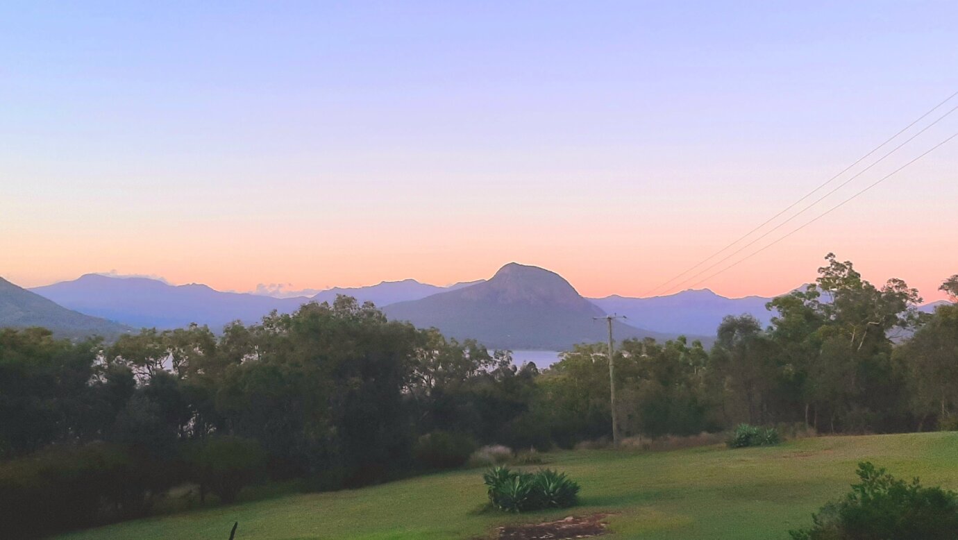 Sunset scene over the gardens at Moogie House to the Main Ranges mountains in the distance
