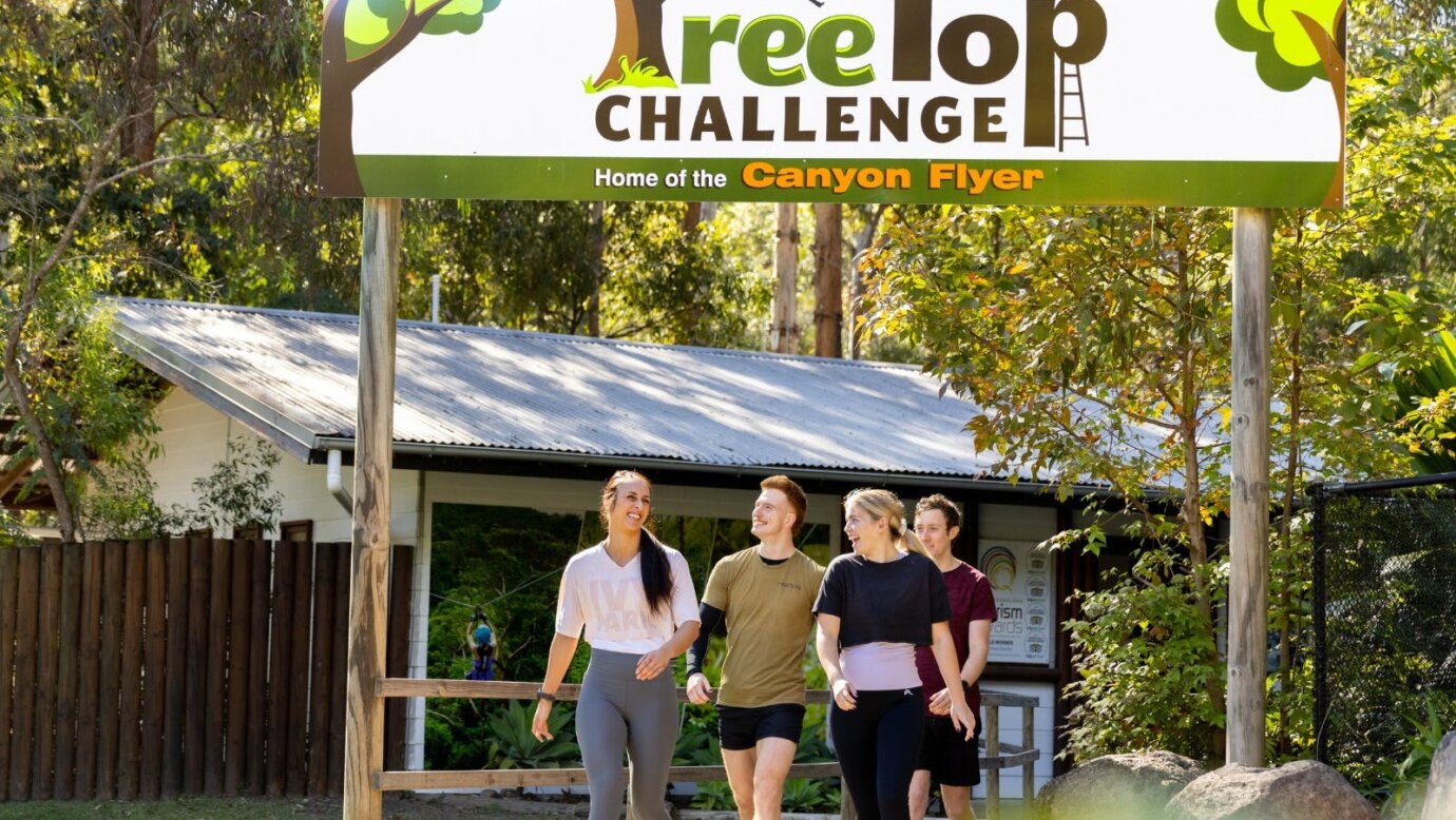 TreeTop Challenge building with smiling guests leaving