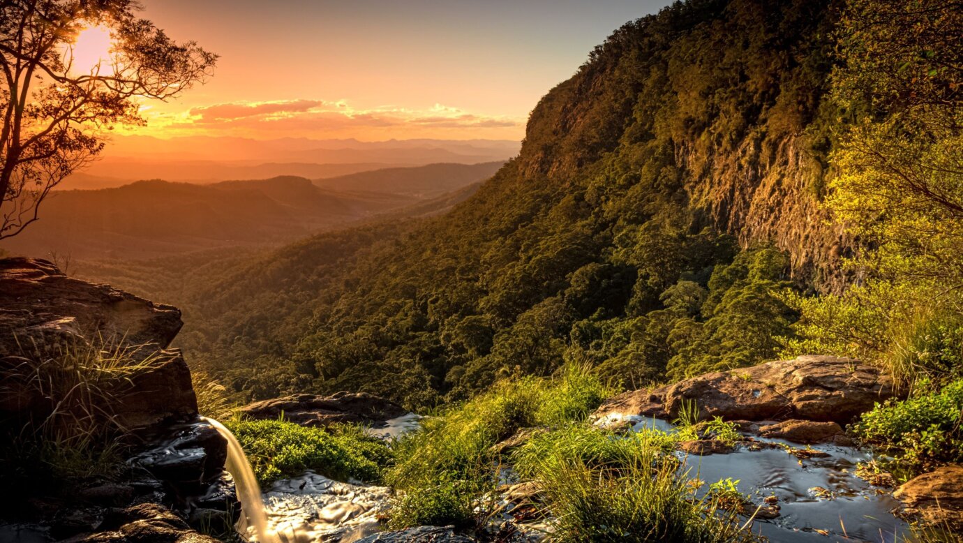 A waterfall flows into the valley below in world-heritage protected Lamington National Park