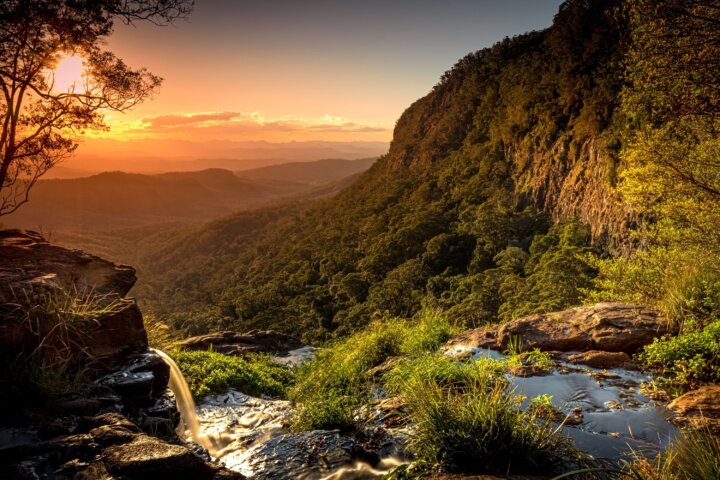 A waterfall flows into the valley below in world-heritage protected Lamington National Park