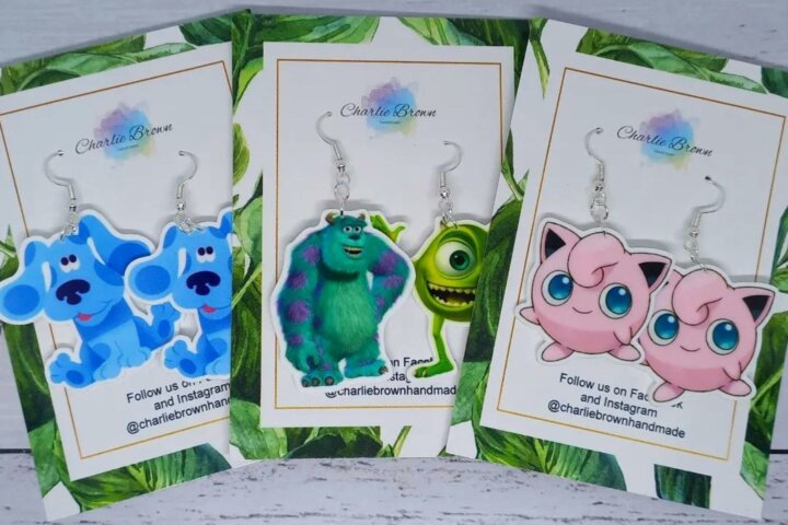 Three pairs of colourful picture earrings featuring cartoon-style designs