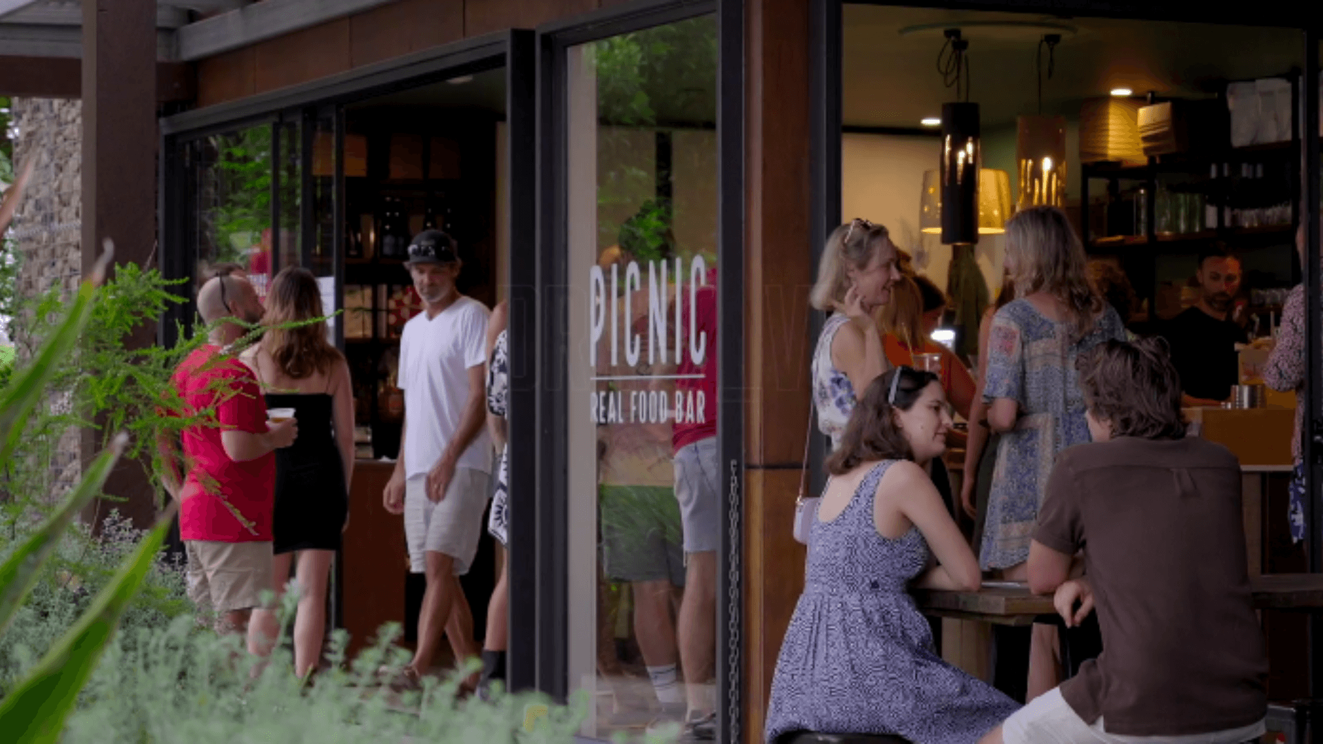 People sitting and walking outside Picnic Real Food Bar, Tamborine Mountain