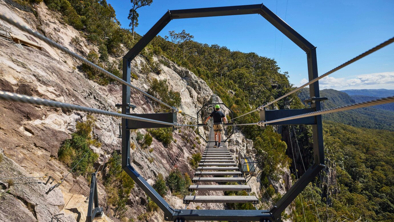 Man walking across Via Ferrata at Happitat Adventure Park