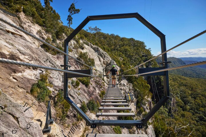 Man walking across Via Ferrata at Happitat Adventure Park