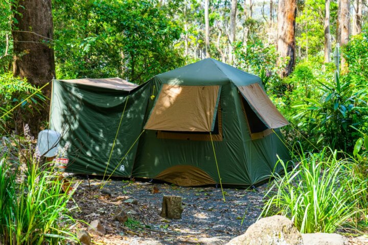 Image shows a large tent set up on a campsite