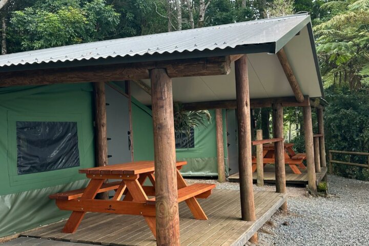 Image shows the exterior courtyard and fire pit of the Safari Tents