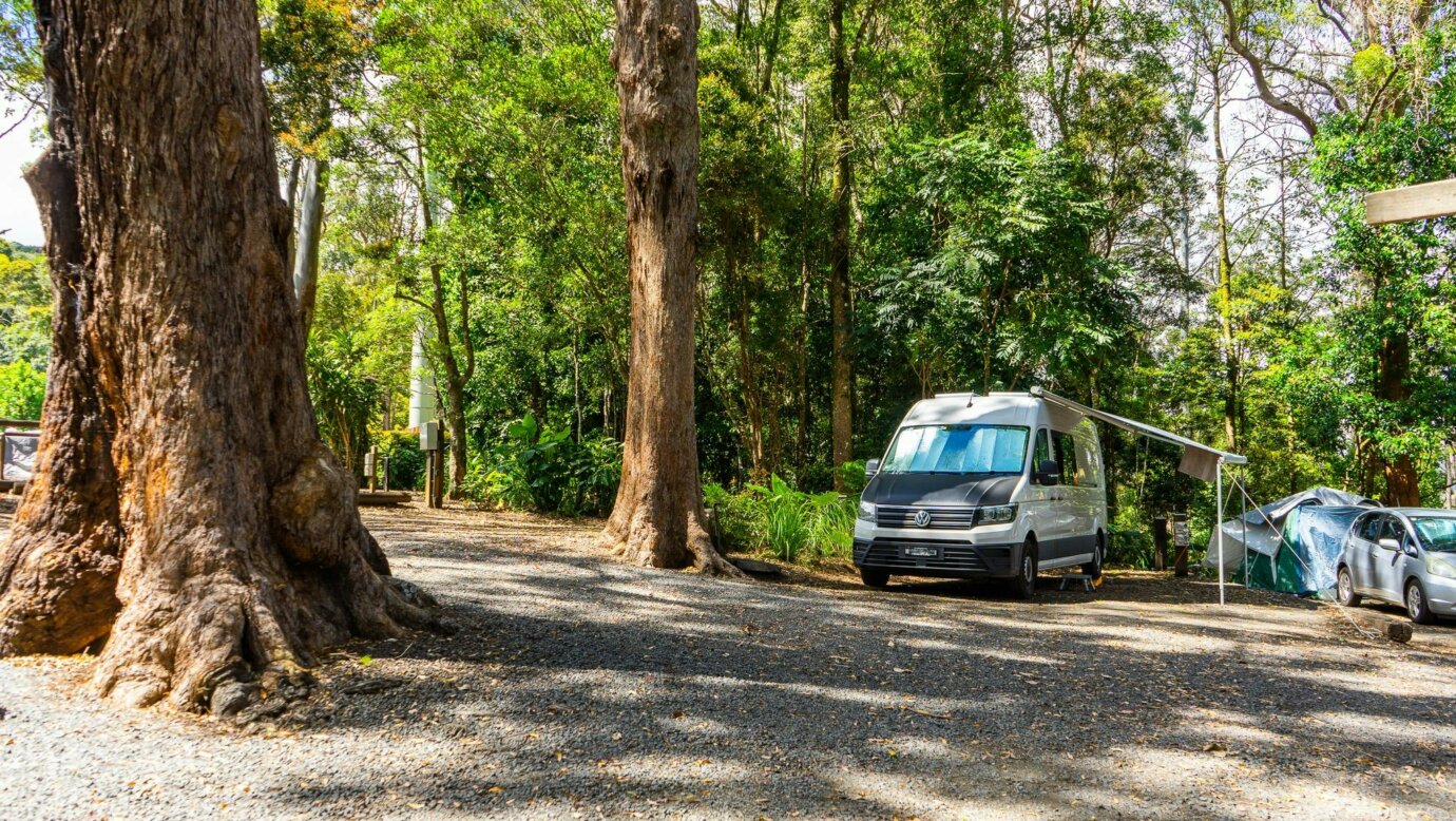 Image shows a campervan on a drive in site
