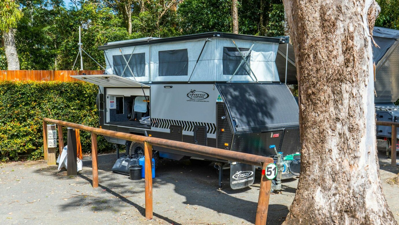 Image shows a caravan set up at the campsite