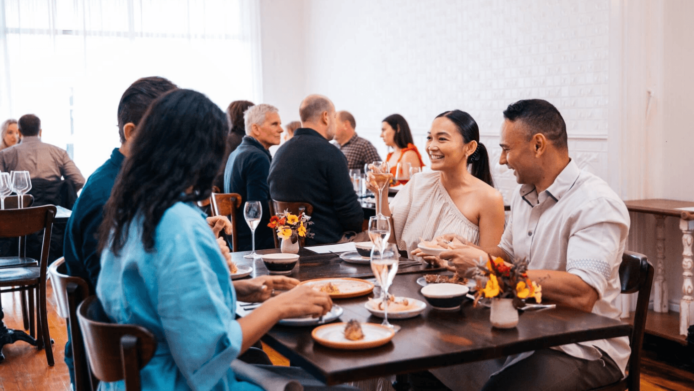 Group sitting at Blume Restaurant enjoying the dining experience