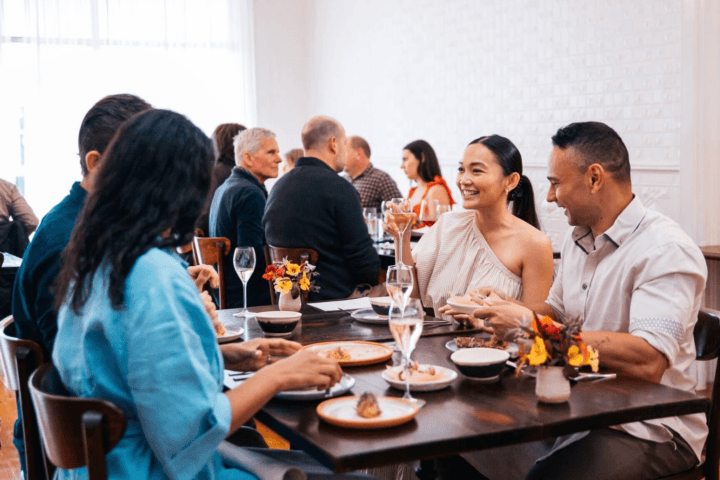 Group sitting at Blume Restaurant enjoying the dining experience