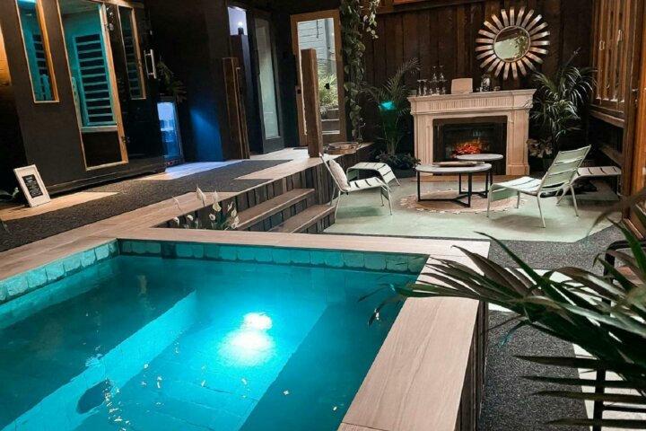 Spa room with plunge pool, fireplace, steam room and lounging area