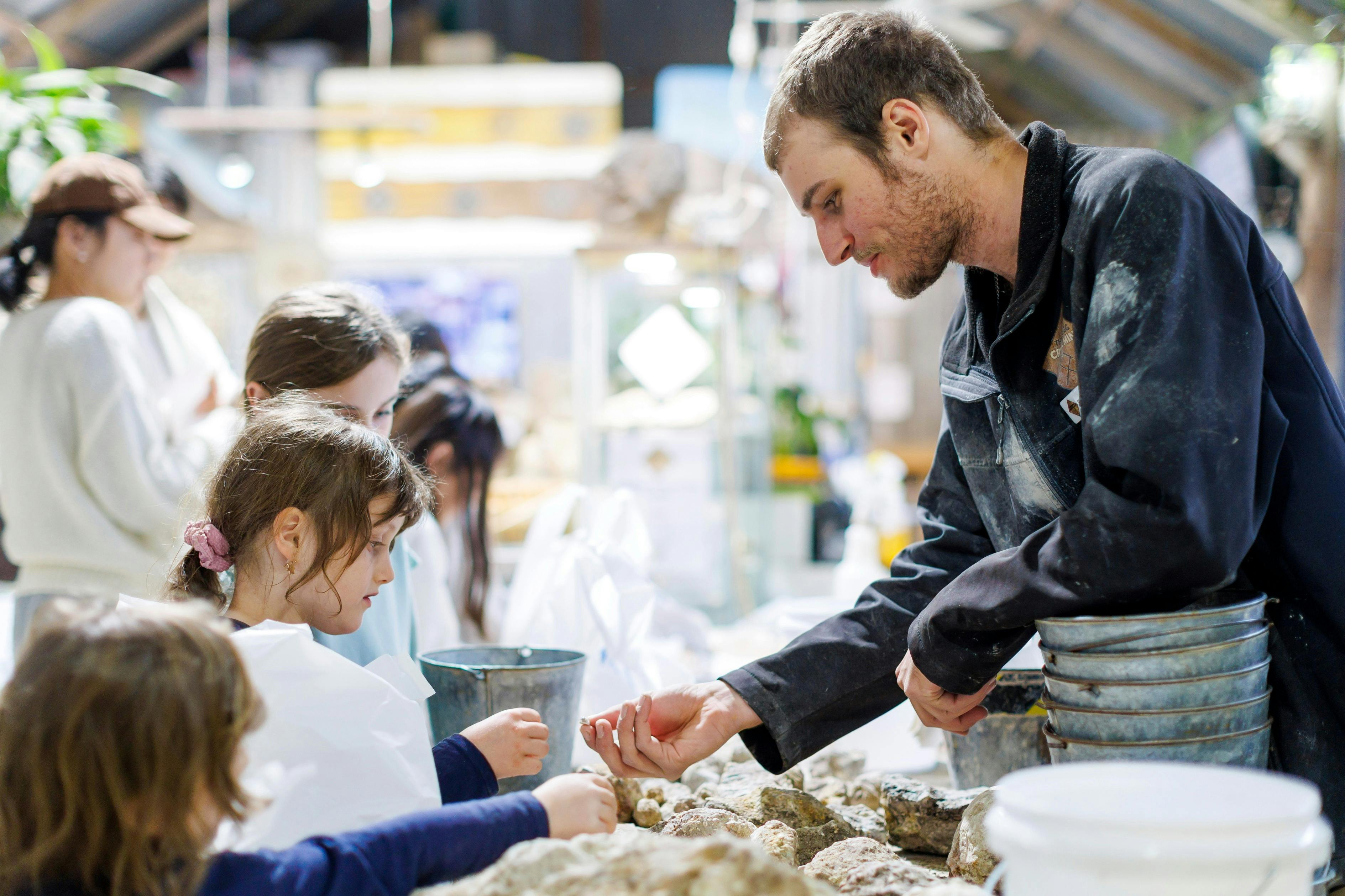 Staff sorting the finds from a family who went fossicking.