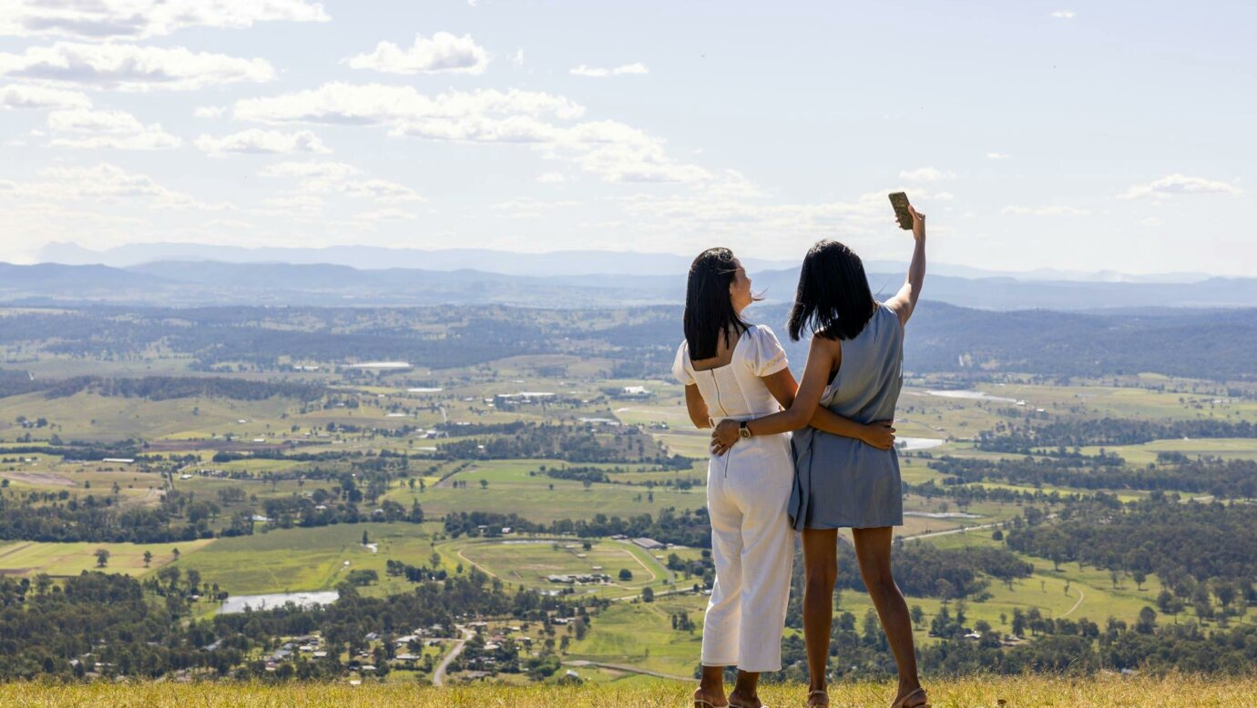 Two ladies taking photos at scenic lookout