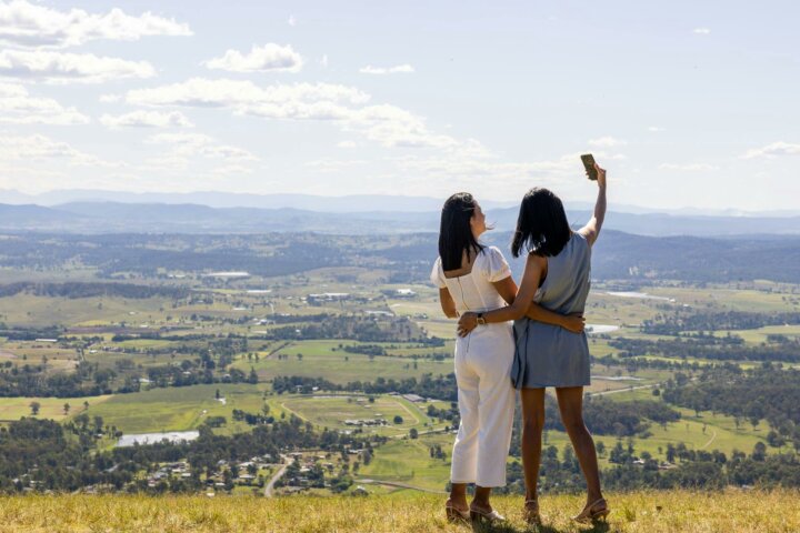 Two ladies taking photos at scenic lookout