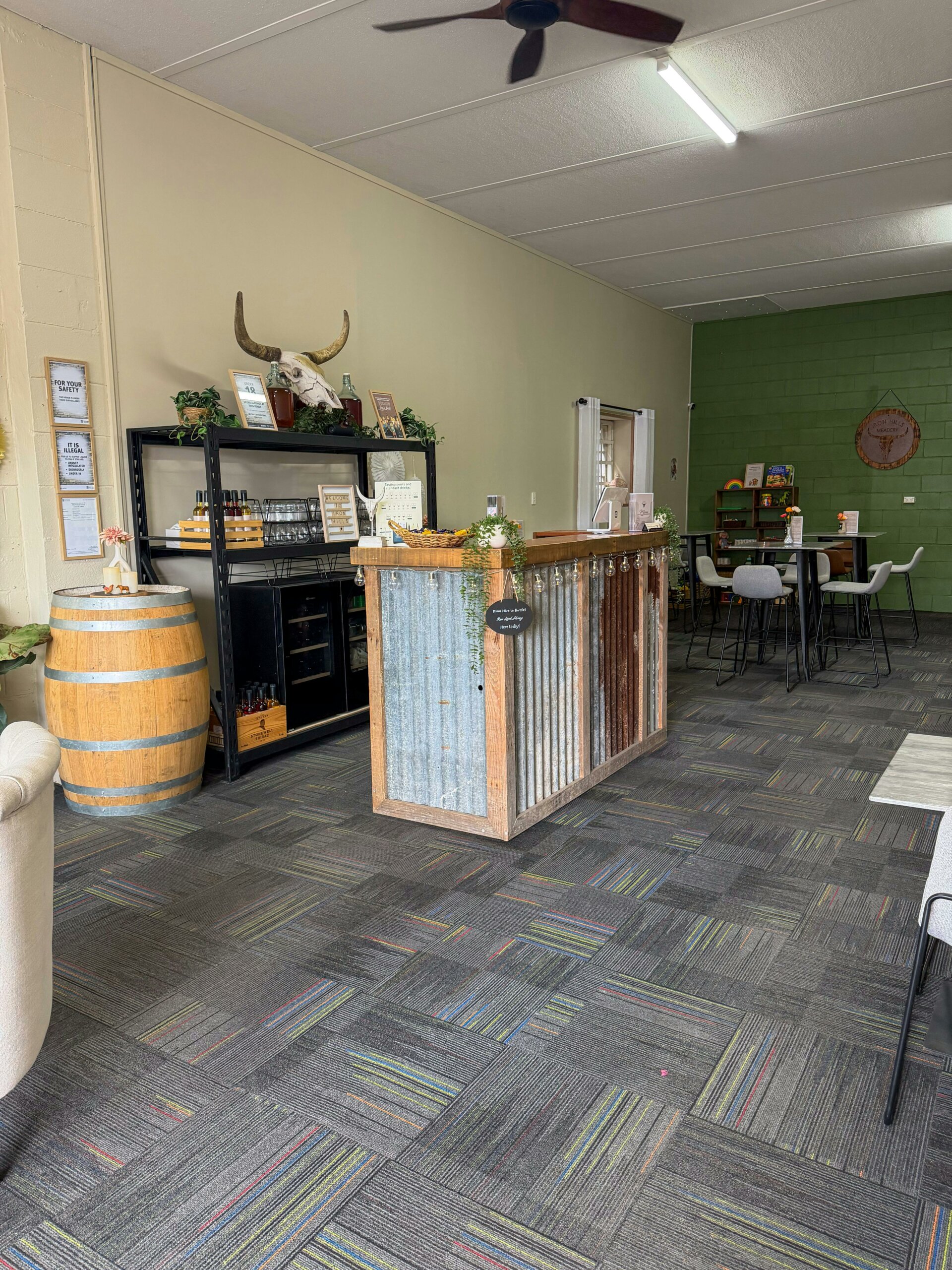 Rustic bar area with seating in background. Ordering is done at this area.